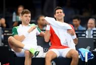 Filip Krajinovic and Novak Djokovic chat during the 'A Day at the Drive' exhibition tournament